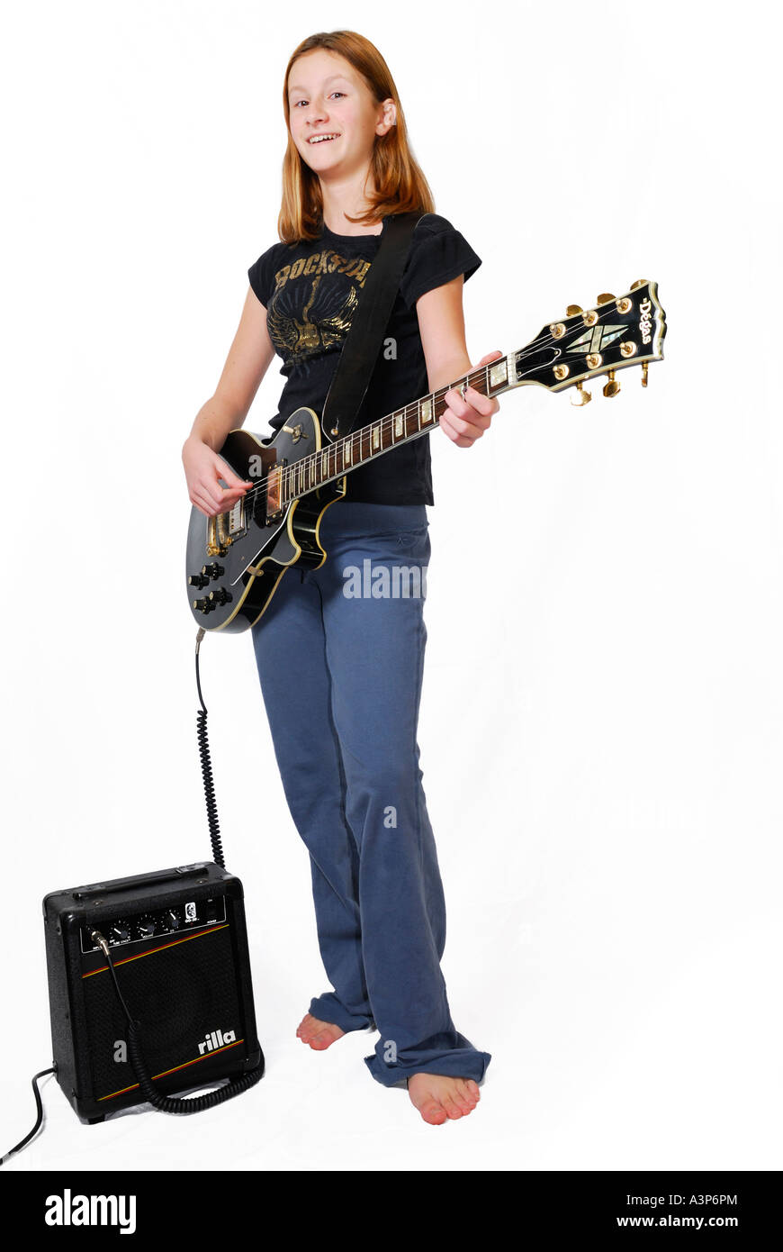 Smiling teenage girl playing electric guitar with amplifier on white  background Stock Photo - Alamy