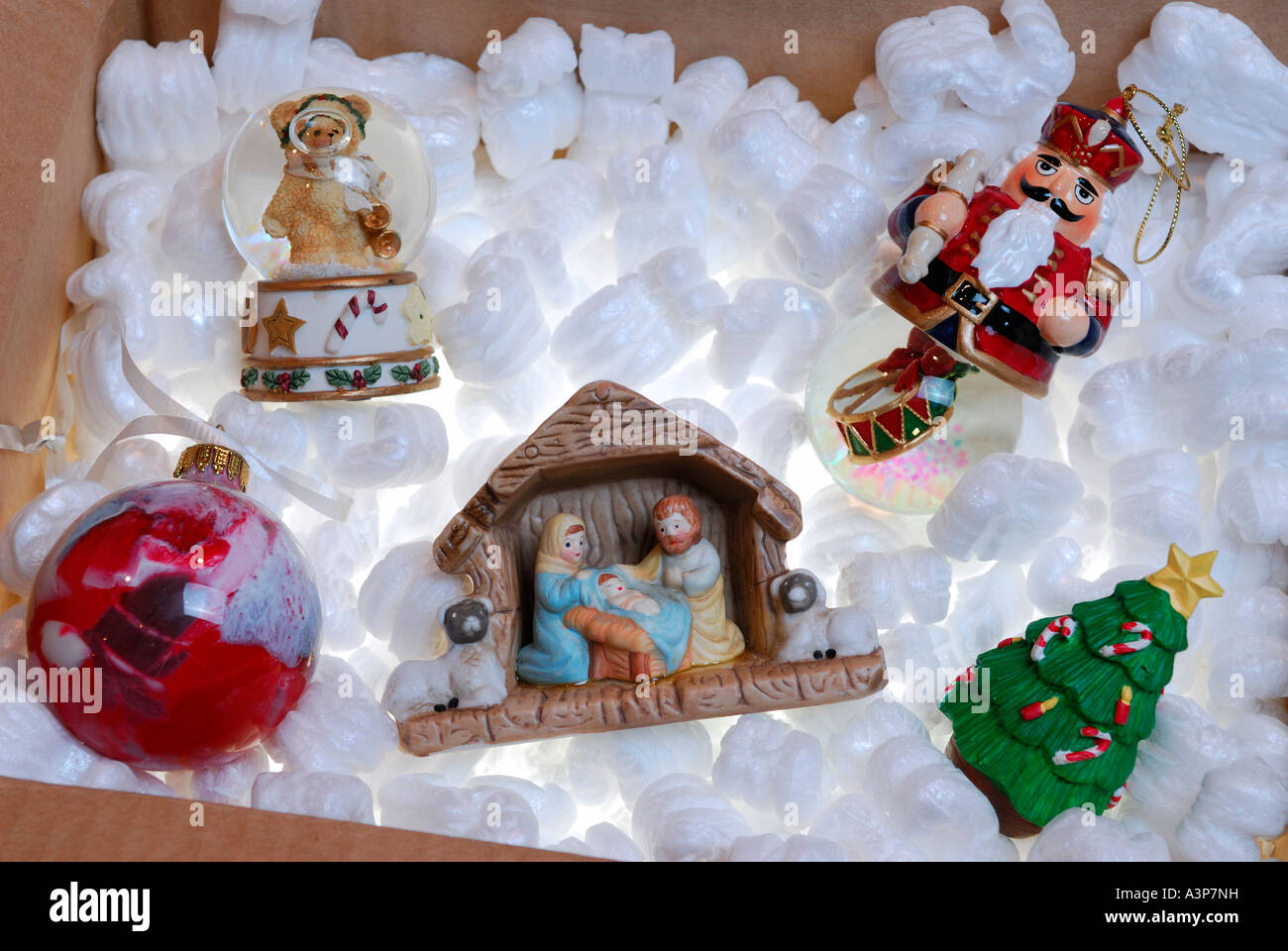 Nativity set and Christmas ornaments stored in a box of backlit styrofoam Stock Photo