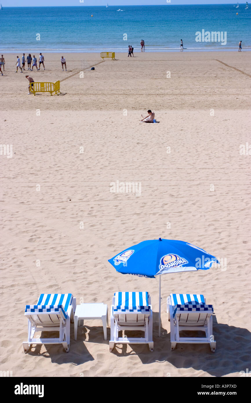 Group of people relaxing on beach under umbrella hi-res stock photography  and images - Alamy