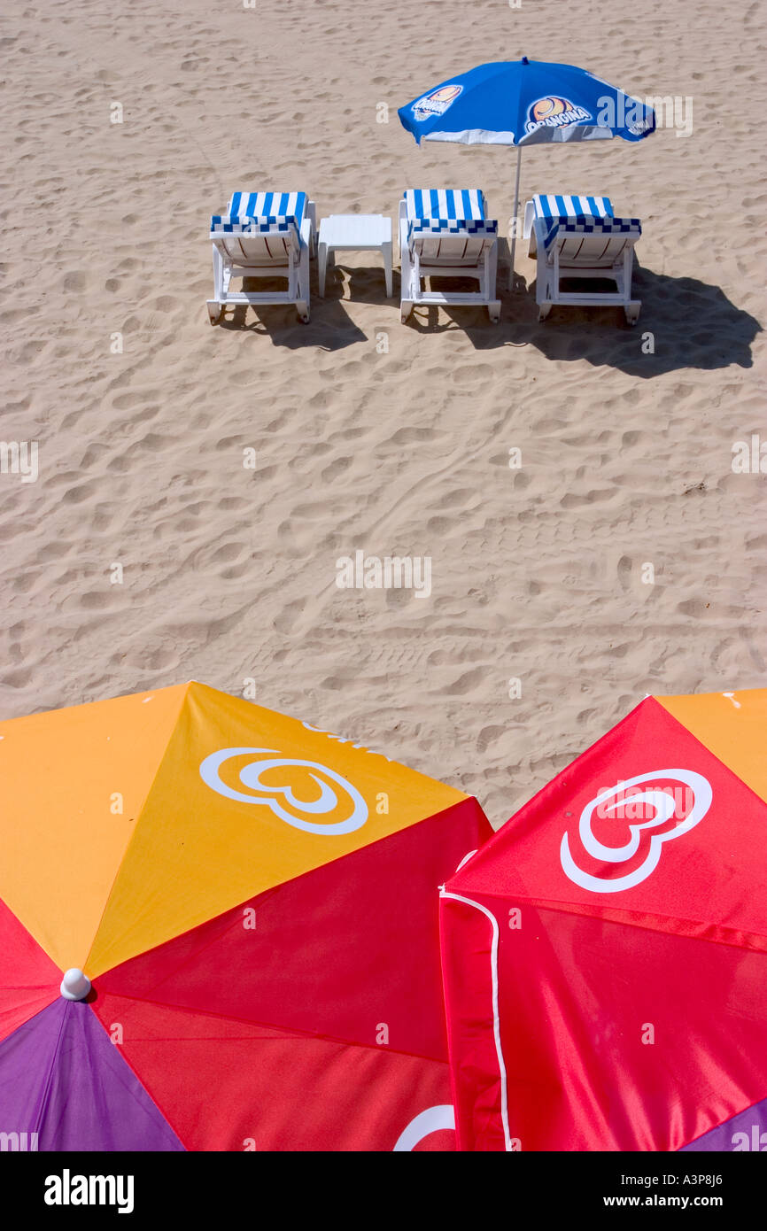 Group of people relaxing on beach under tent hires stock photography