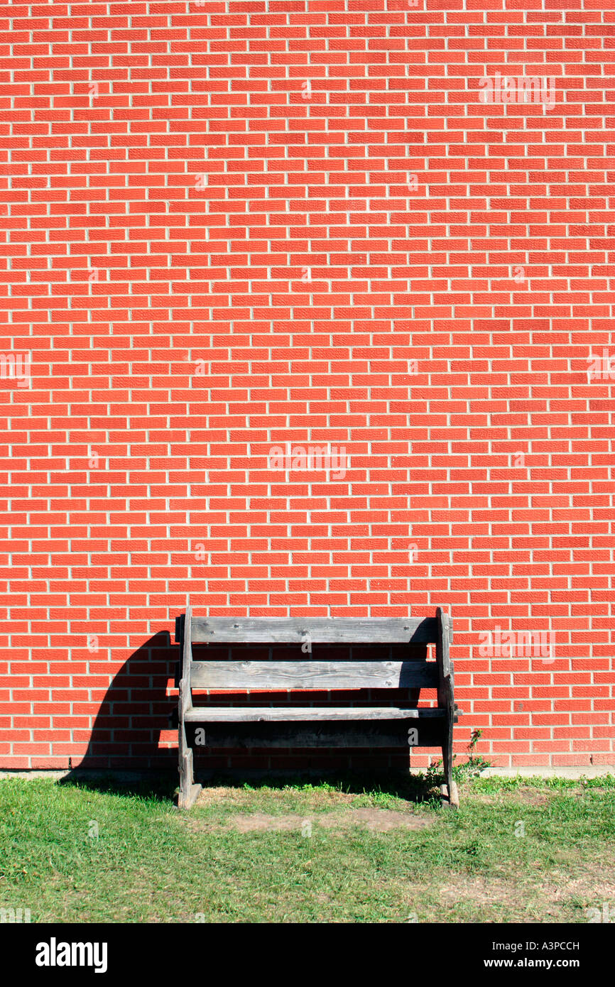 Bench and brick wall Stock Photo