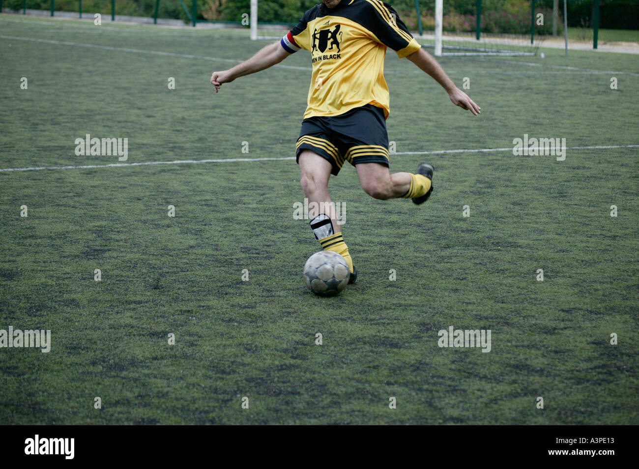 football player kicks the ball Stock Photo Alamy