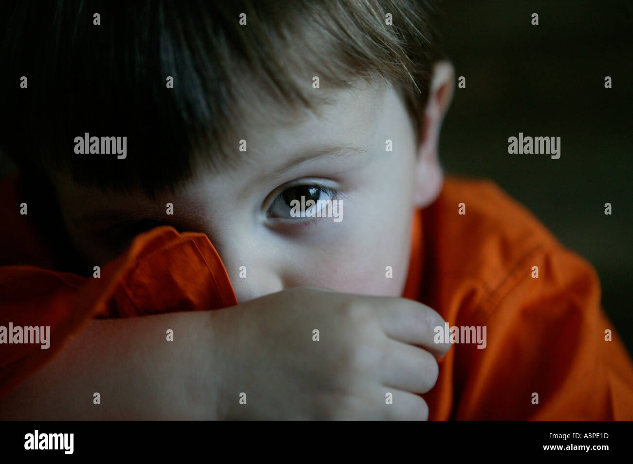 young caucasian boy in orange shirt Stock Photo - Alamy