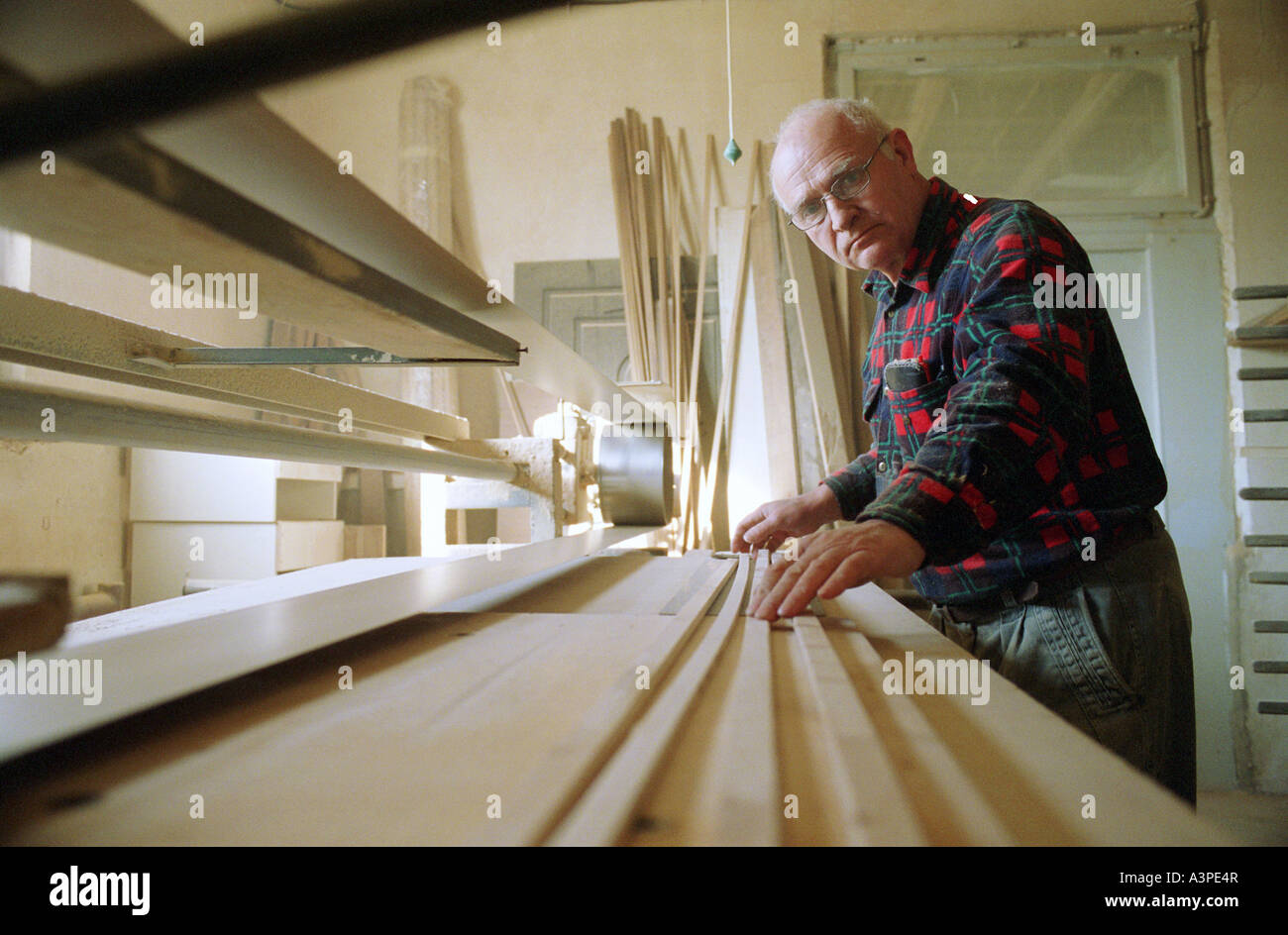 An elderly carpenter at work, Poland Stock Photo Alamy