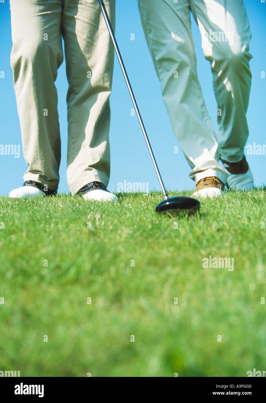 Golfers walking, low section Stock Photo