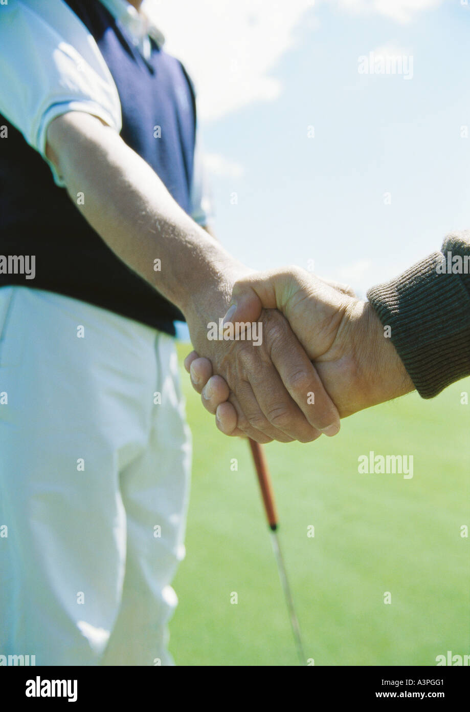 Golfers shaking hands Stock Photo