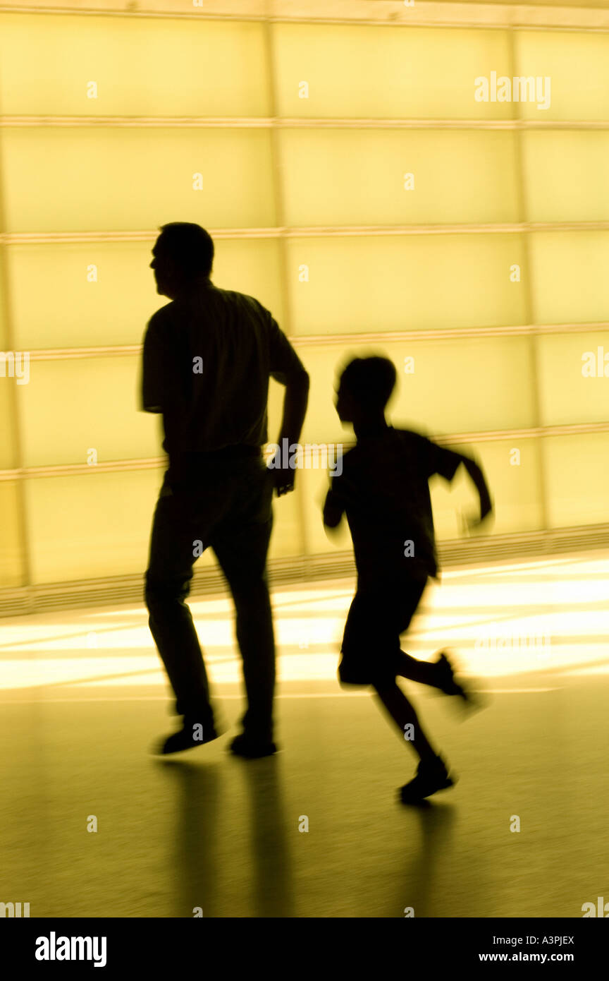 Silhouette of a small boy running after his father Stock Photo - Alamy