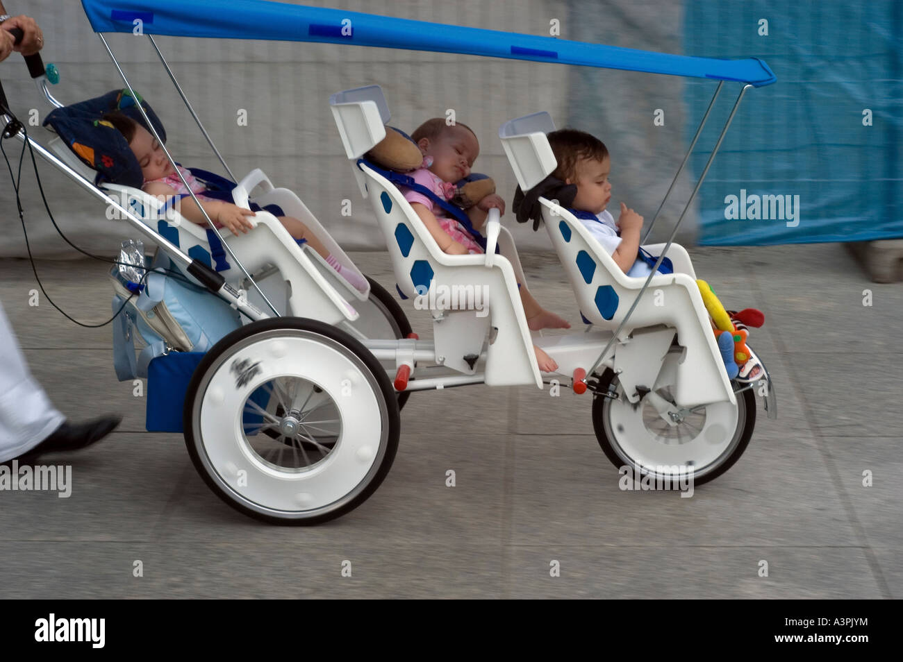 Triplets in a baby buggy, Berlin, Germany Stock Photo - Alamy