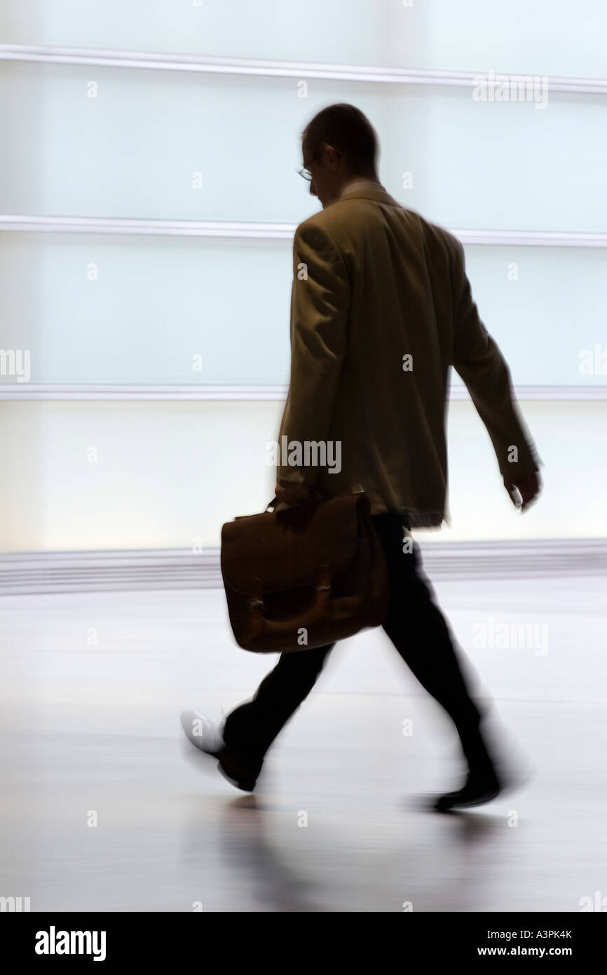 Silhouette of a walking man with suitcase Stock Photo - Alamy