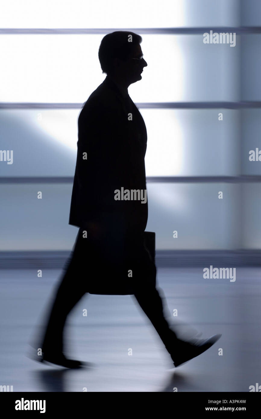 Silhouette of a walking man with suitcase Stock Photo - Alamy