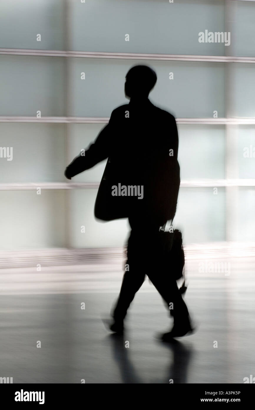 Silhouette of a walking man with suitcase Stock Photo - Alamy