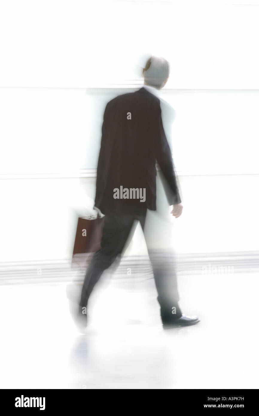 Silhouette of a walking man with suitcase Stock Photo - Alamy