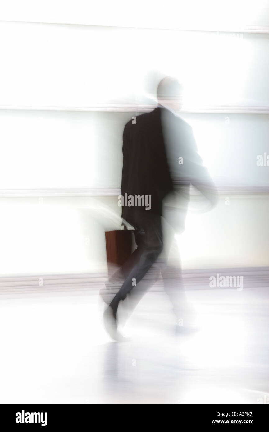 Silhouette of a walking man with suitcase Stock Photo - Alamy
