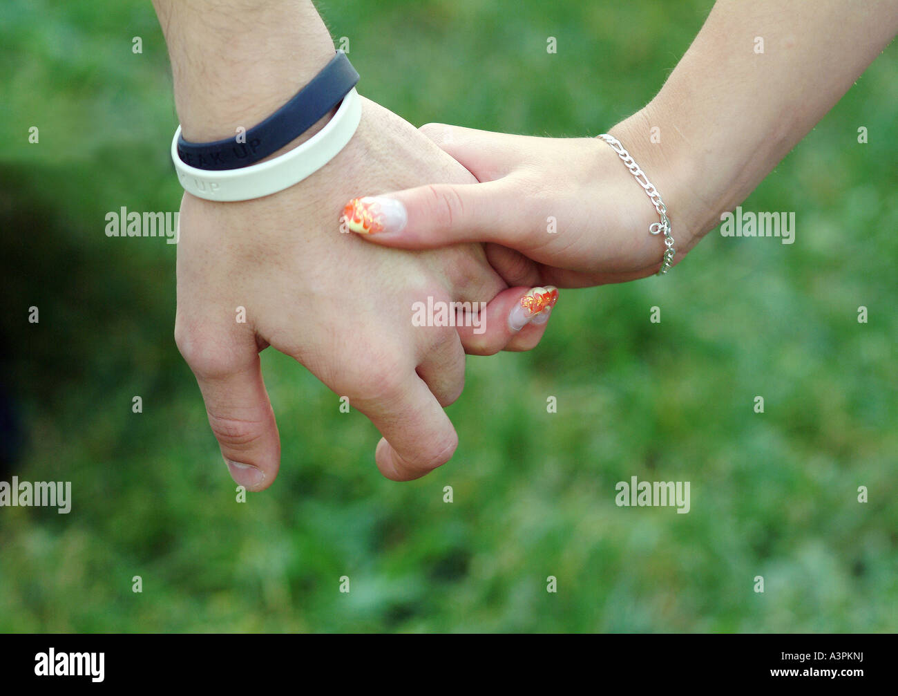A young couple holding hands Stock Photo - Alamy