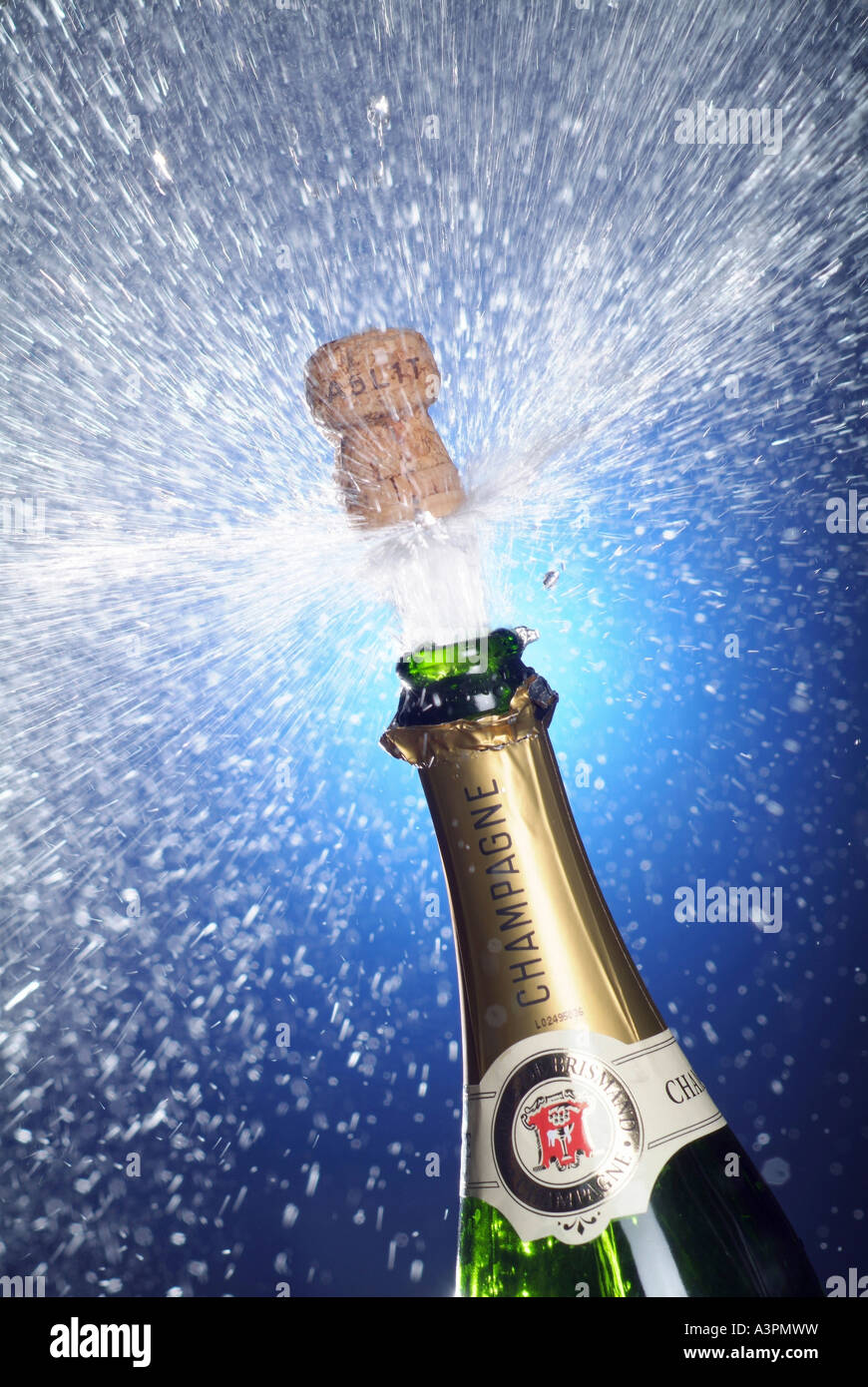 Cork shooting out of a champagne bottle Stock Photo