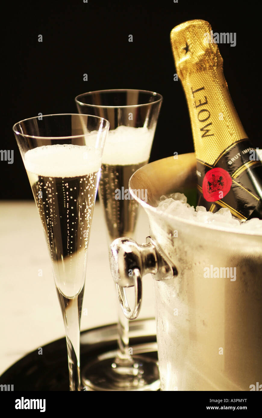 Champagne glasses and a champagne bottle in an ice bucket Stock Photo