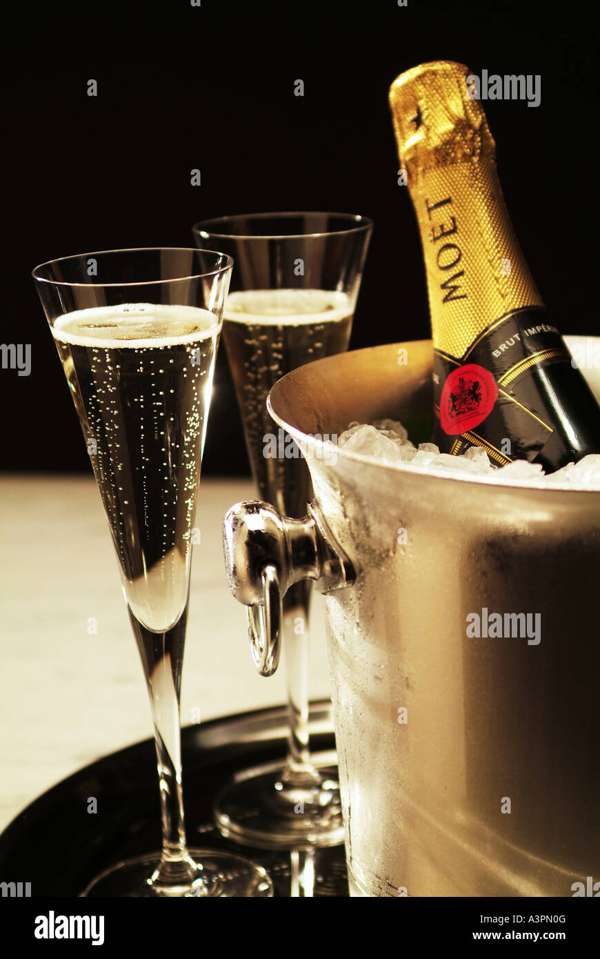 Champagne glasses and a champagne bottle in an ice bucket Stock Photo -  Alamy