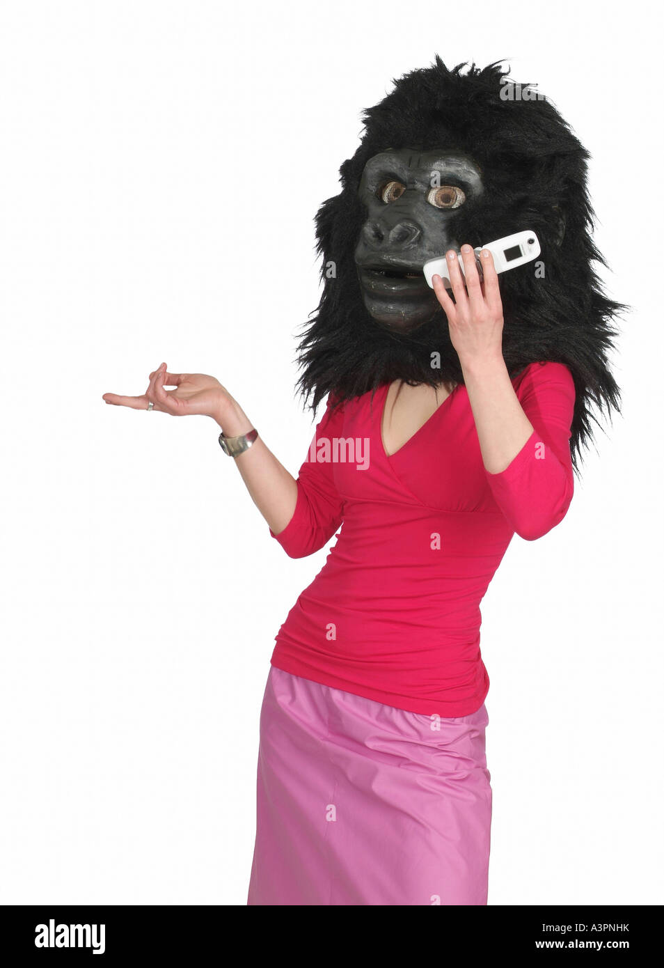 Woman wearing the head of a gorilla costume and making a phone call Stock Photo