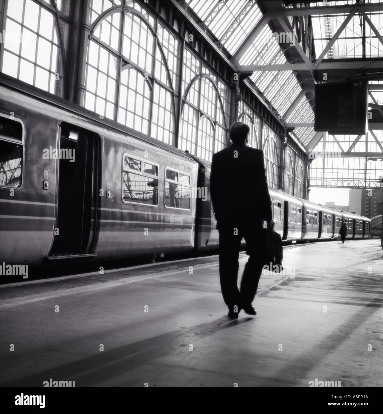 Commuter boarding a train at Waterloo station London England Stock Photo