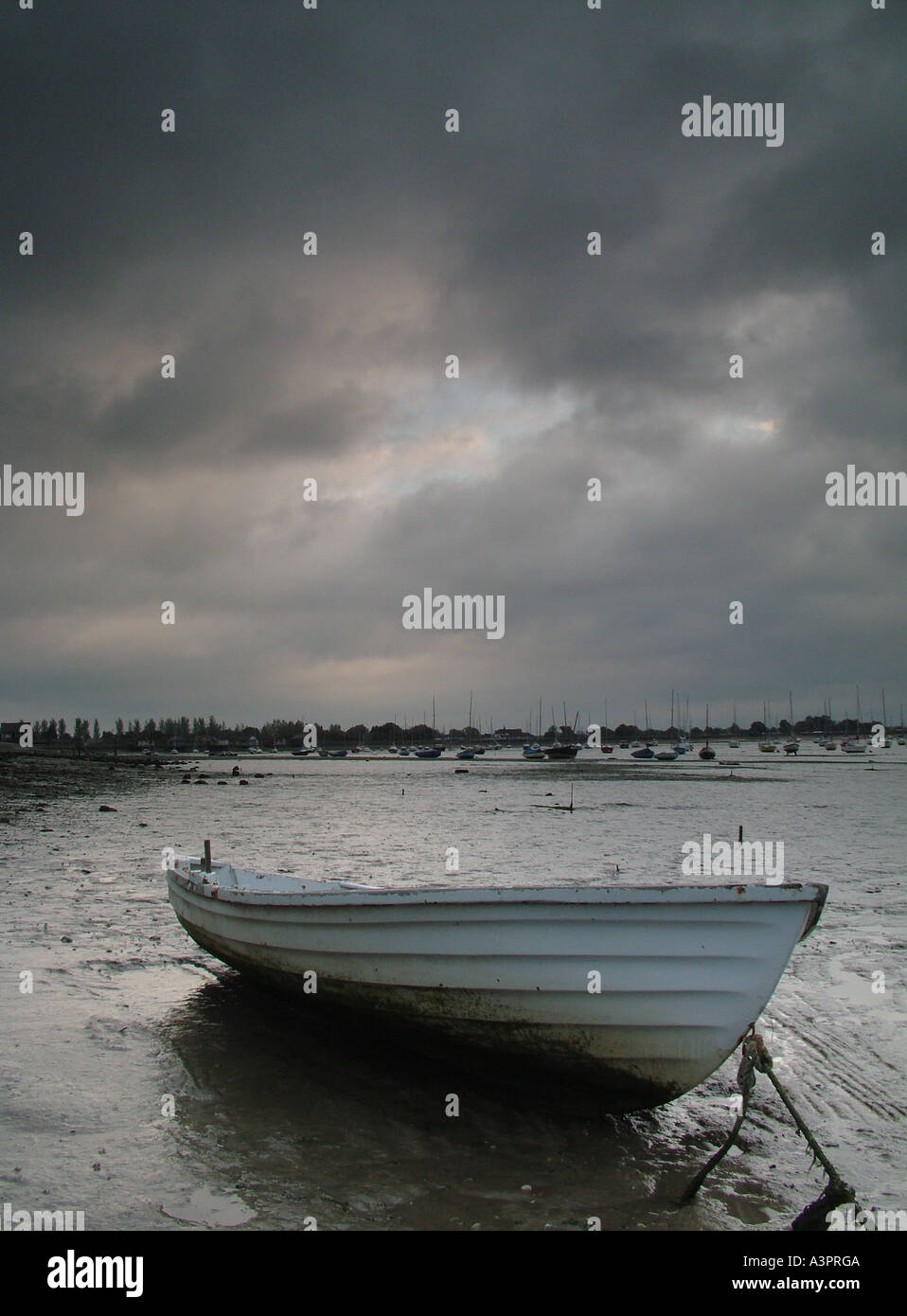 Lone boat at dawn on the River Blackwater Heybridge Basin Essex England