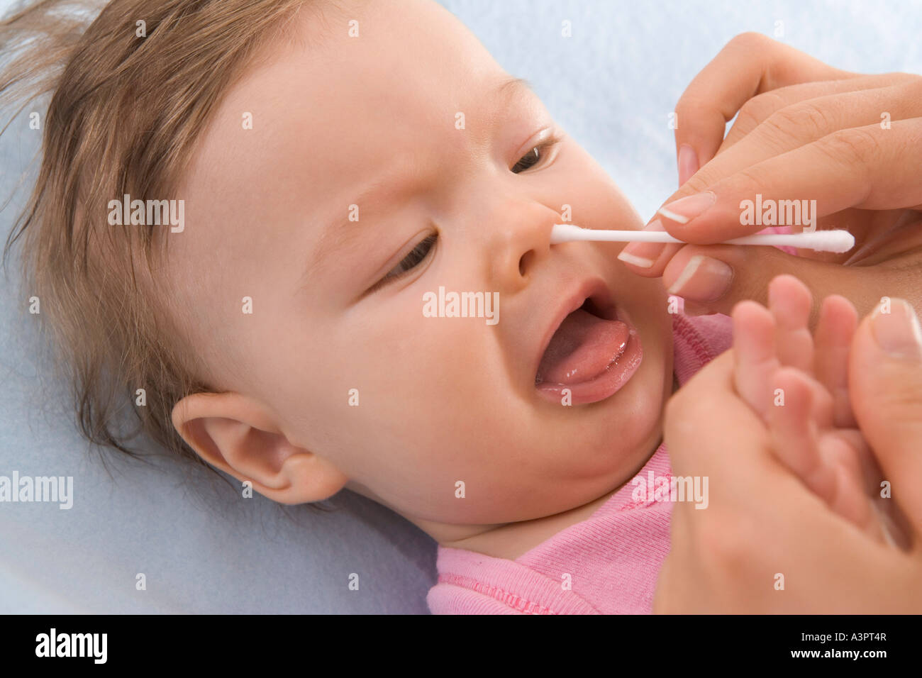 mother cleaning baby's nose Stock Photo Alamy