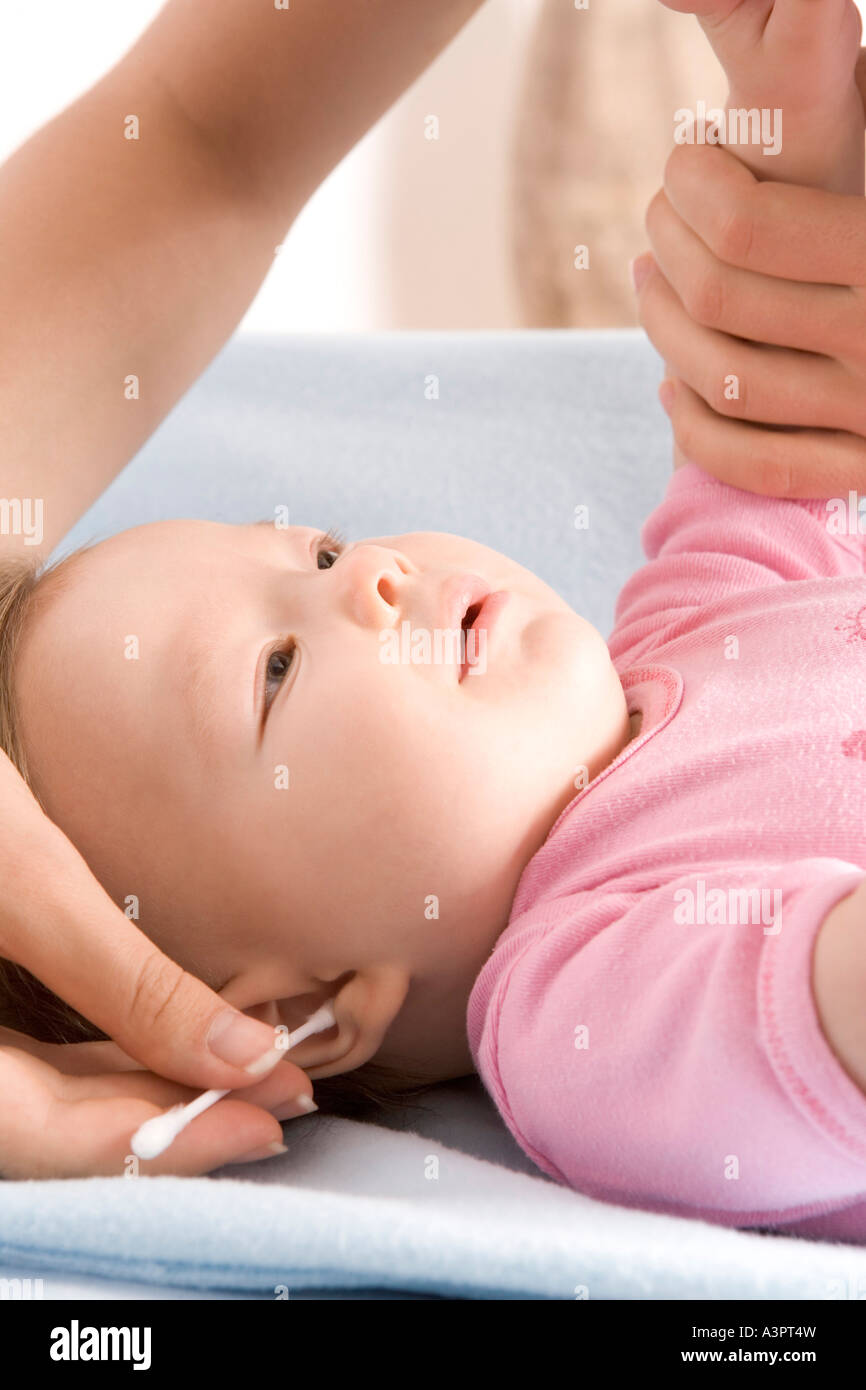 mother cleaning baby's ear Stock Photo Alamy