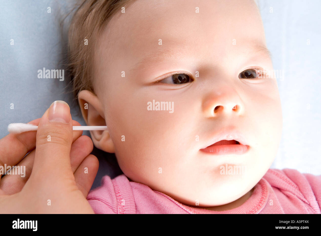 mother cleaning baby's ear Stock Photo Alamy