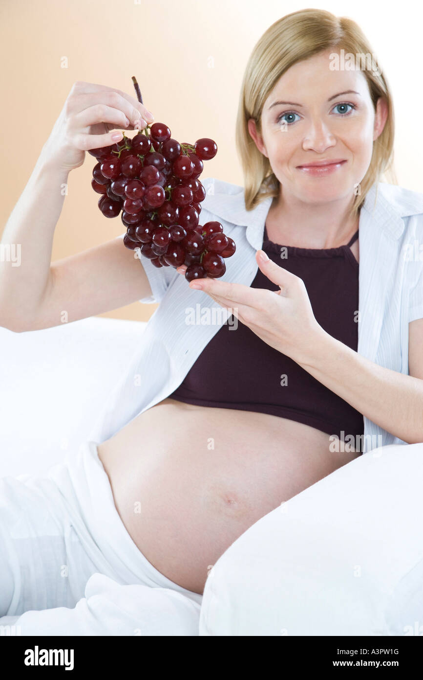 pregnant woman eating grapes Stock Photo Alamy