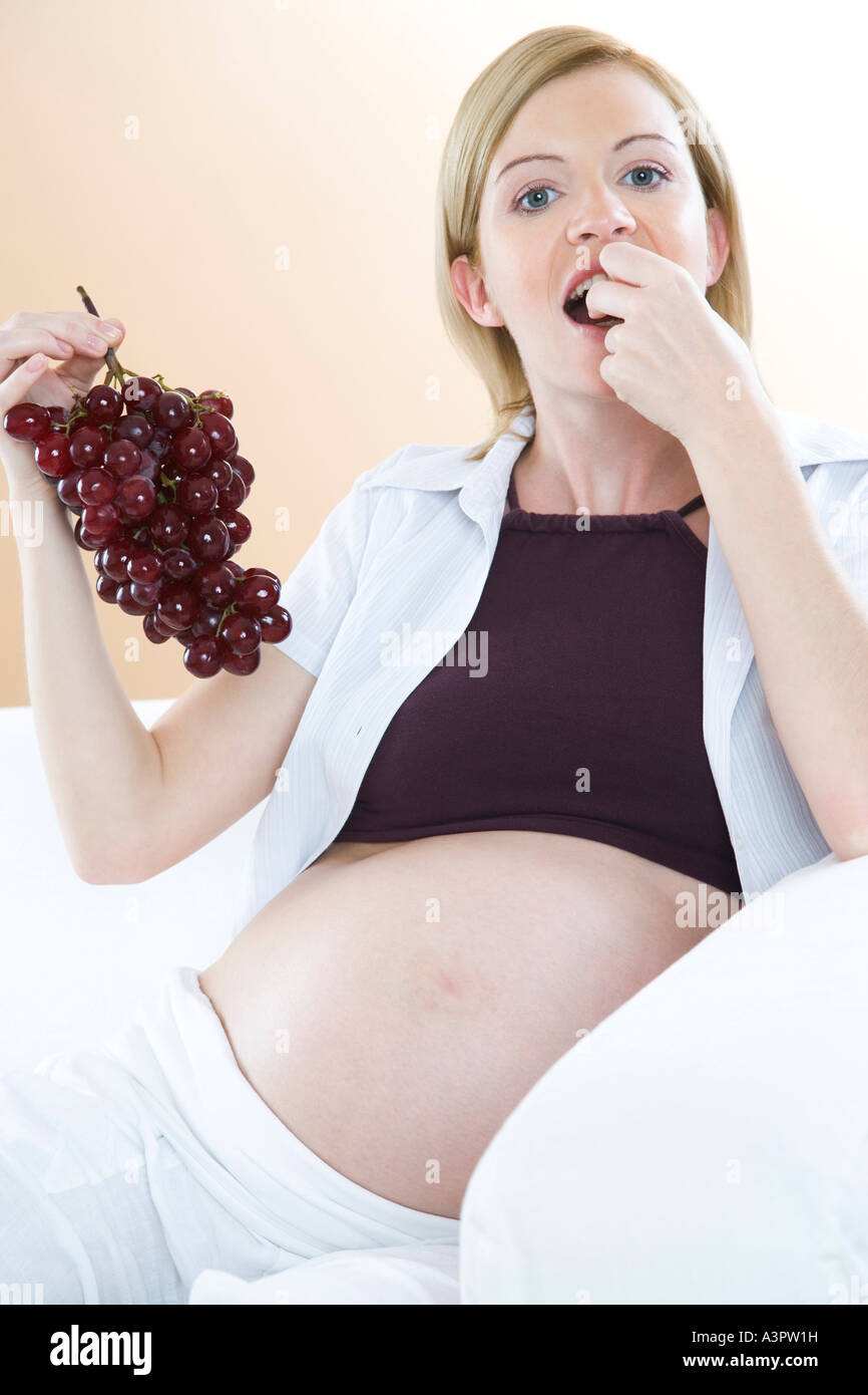 pregnant woman eating grapes Stock Photo Alamy