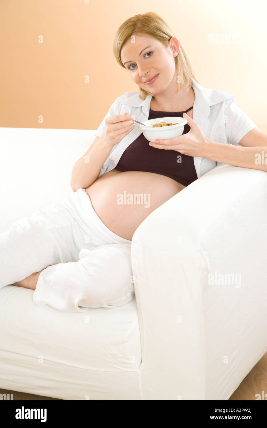 pregnant woman eating muesli Stock Photo Alamy