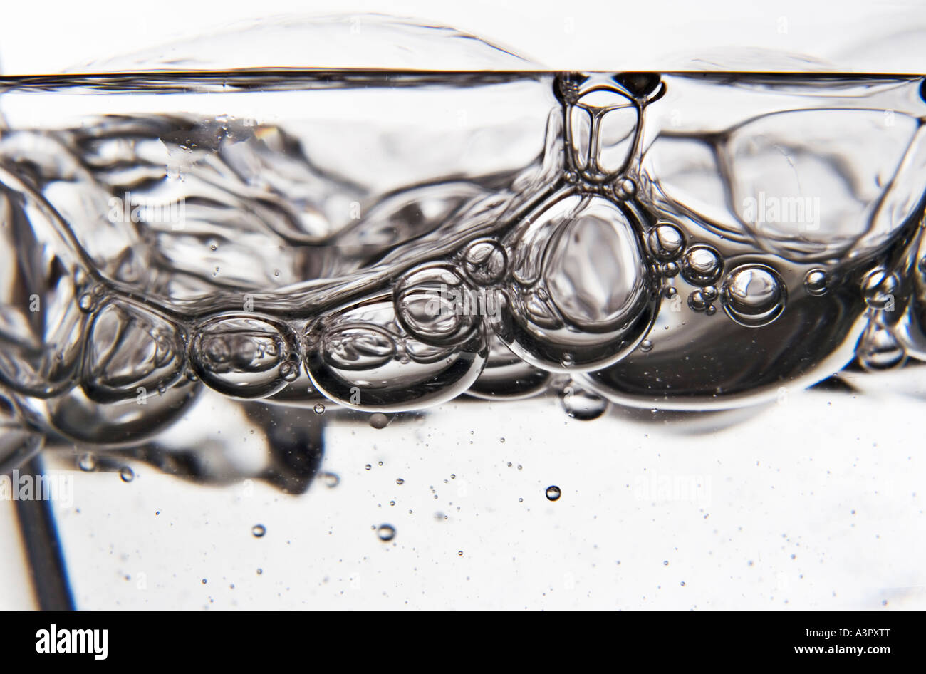 Blowing bubbles through a straw in a glass of water Stock Photo Alamy
