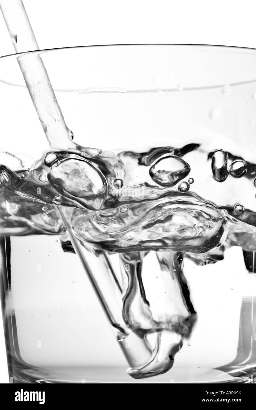 Blowing bubbles through a straw in a glass of water Stock Photo Alamy