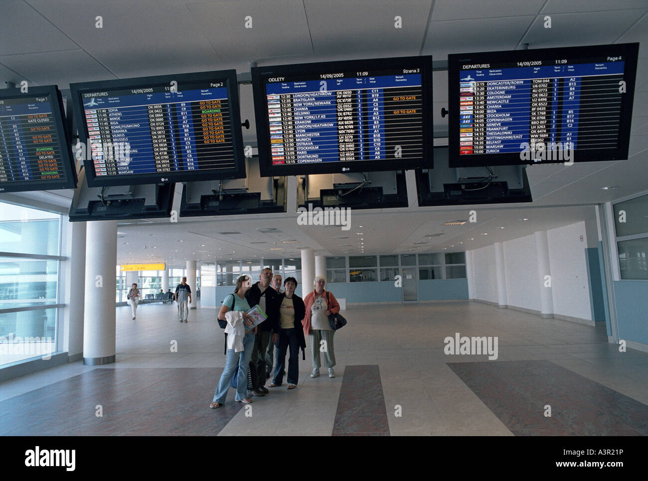 Tourists checking information panels at the Ruzyne airport in Prague, Czech Republic Stock Photo