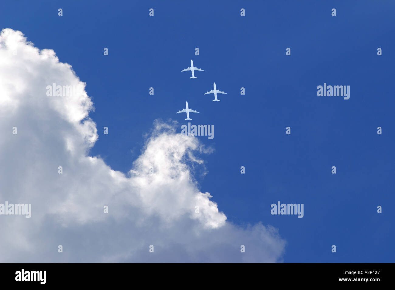 three white passenger airplanes in blue sky Stock Photo