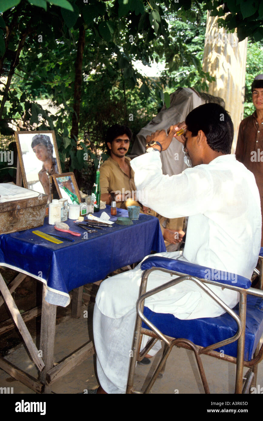 openair barber in the Atmospheric daily  market in  Peshawar,Pakistan Stock Photo