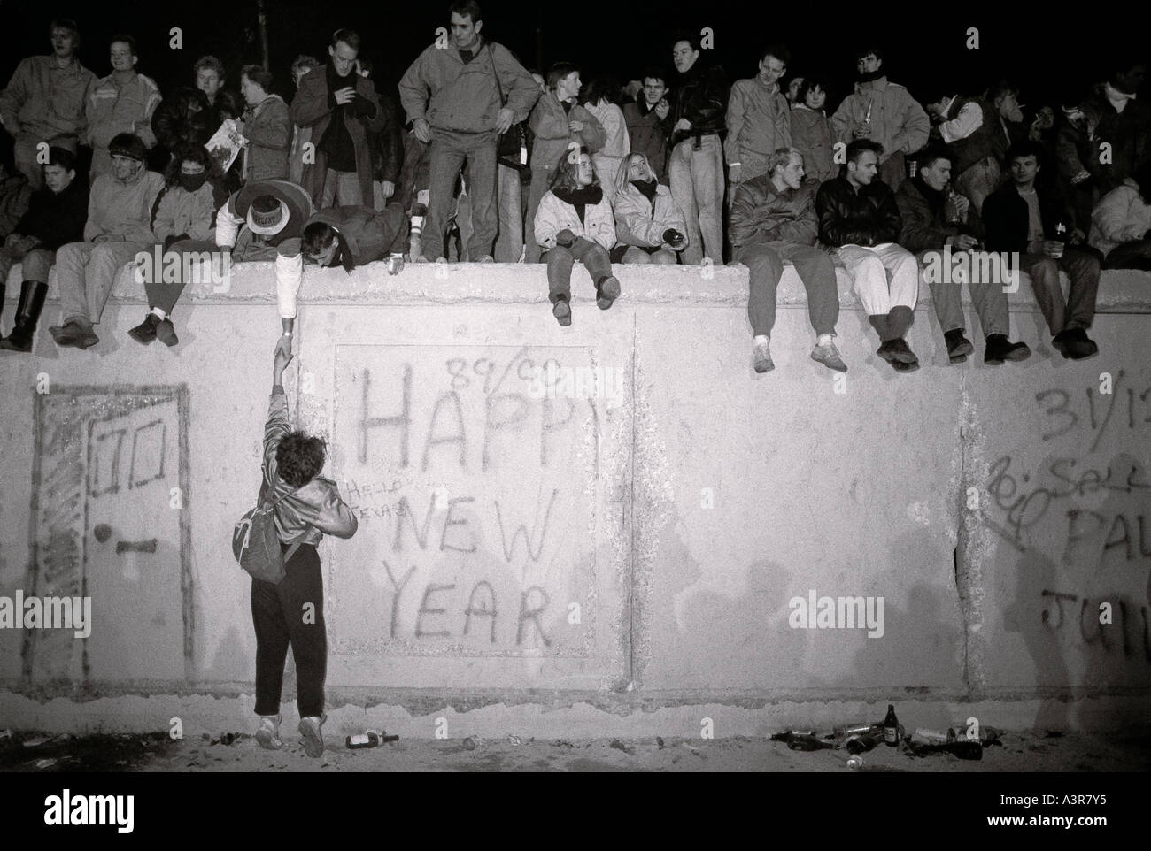 European History. New Year celebrations on the historical Berlin Wall in West Berlin in Germany in Europe during the Cold War. Stock Photo