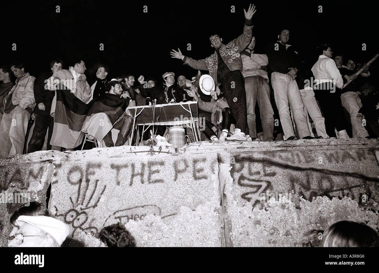 European History. New Year celebrations on the historical Berlin Wall in West Berlin in Germany in Europe during the Cold War. Stock Photo