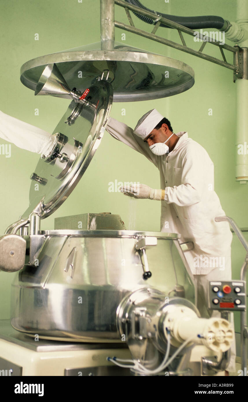 Worker inspecting powder in vat at pharamaceutical manufacturing plant near  Amman Jordan Stock Photo - Alamy