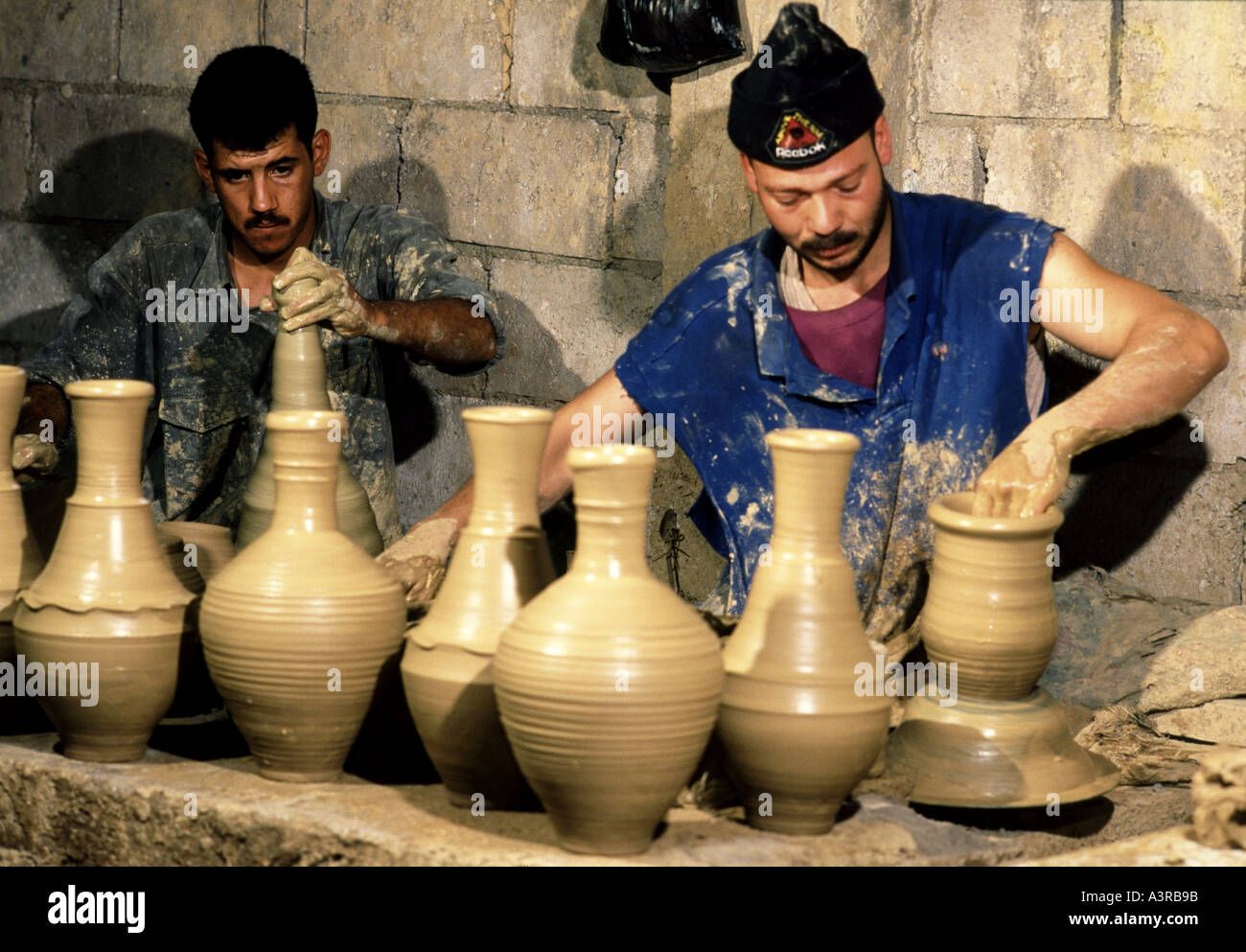 Potters spinning clay pots at factory in Amman Jordan Stock Photo Alamy