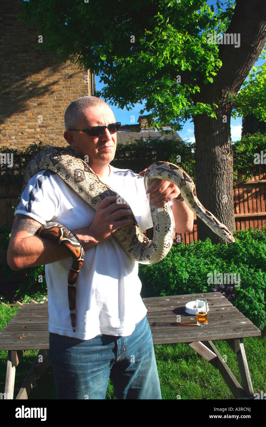 tough man holding snake Stock Photo - Alamy
