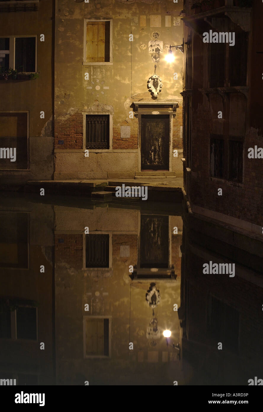 Canal and door at night. San Marco, Venice, Italy Stock Photo