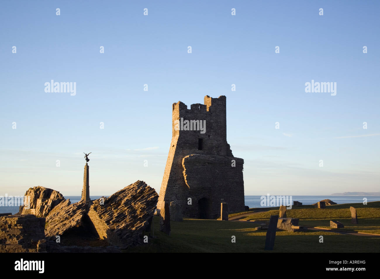 Aberystwyth Castle ruin with remains of Porth Newydd or New Gate on Castle Point with War Memorial and Cardigan Bay. Aberystwyth Stock Photo