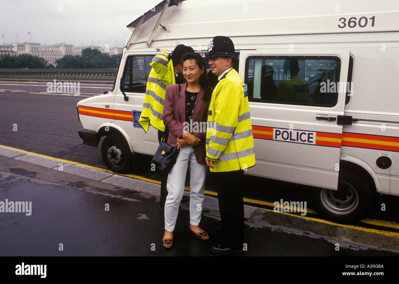 Policeman on duty Westminster Bridge London has his photograph taken with female Japanese tourist UK 1992 1990s HOMER SYKES Stock Photo