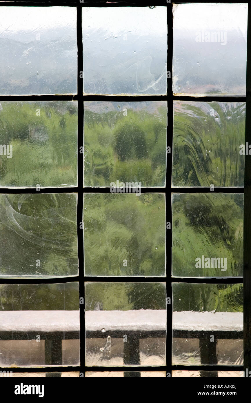 View through a very old window with ancient glass Stock Photo - Alamy