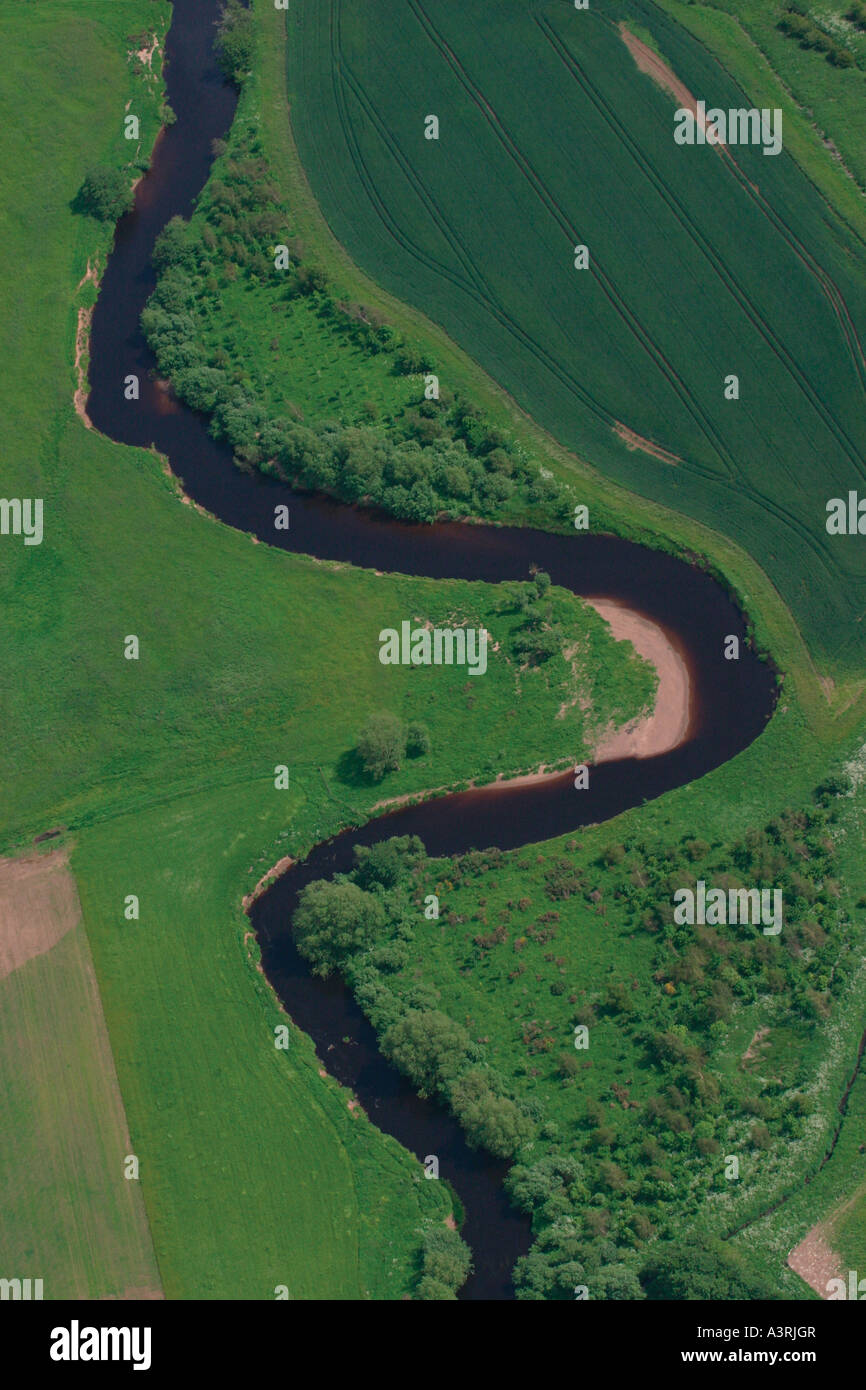 Part of a winding river through fields taken from a microlight in East