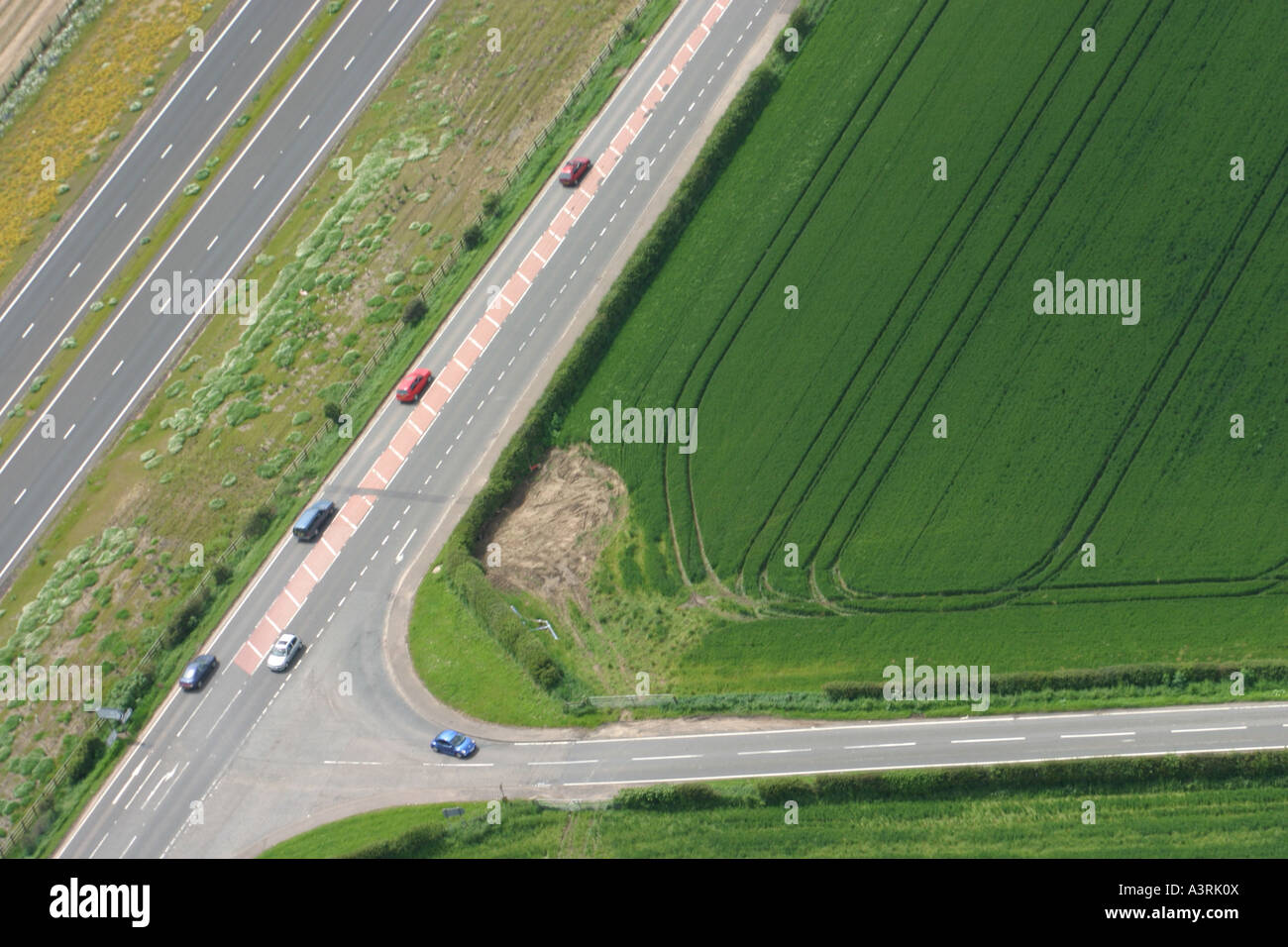 Aerial view of two roads intersecting making a 'V' shape with a field ...