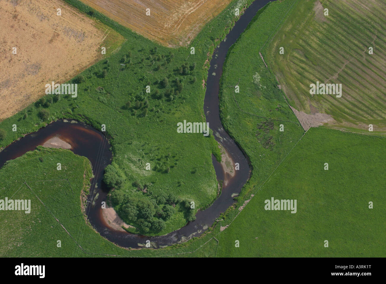 Part of a winding river through fields taken from a microlight in East ...
