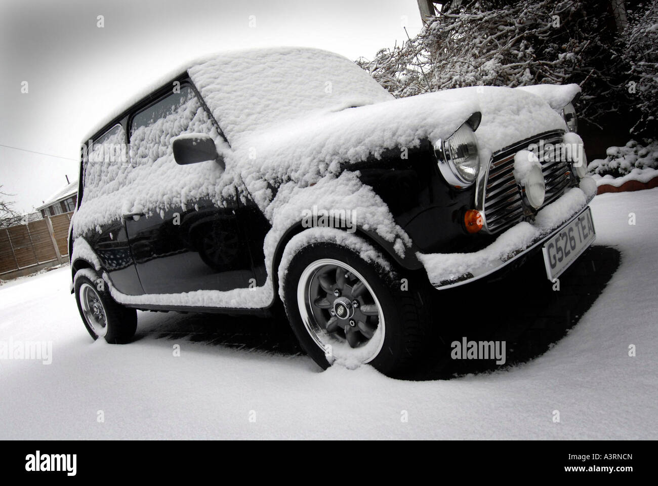CLASSIC AUSTIN ROVER MINI CAR IN SNOW.UK Stock Photo