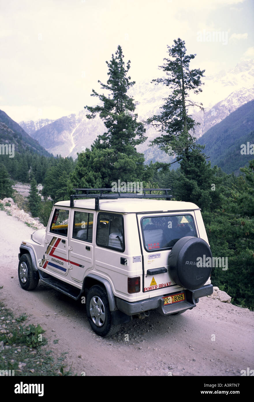 Tourist Jeep on narrow mountain road along Sangla Valley, Himachal Pradesh, India; the road leads towards border with Tibet Stock Photo