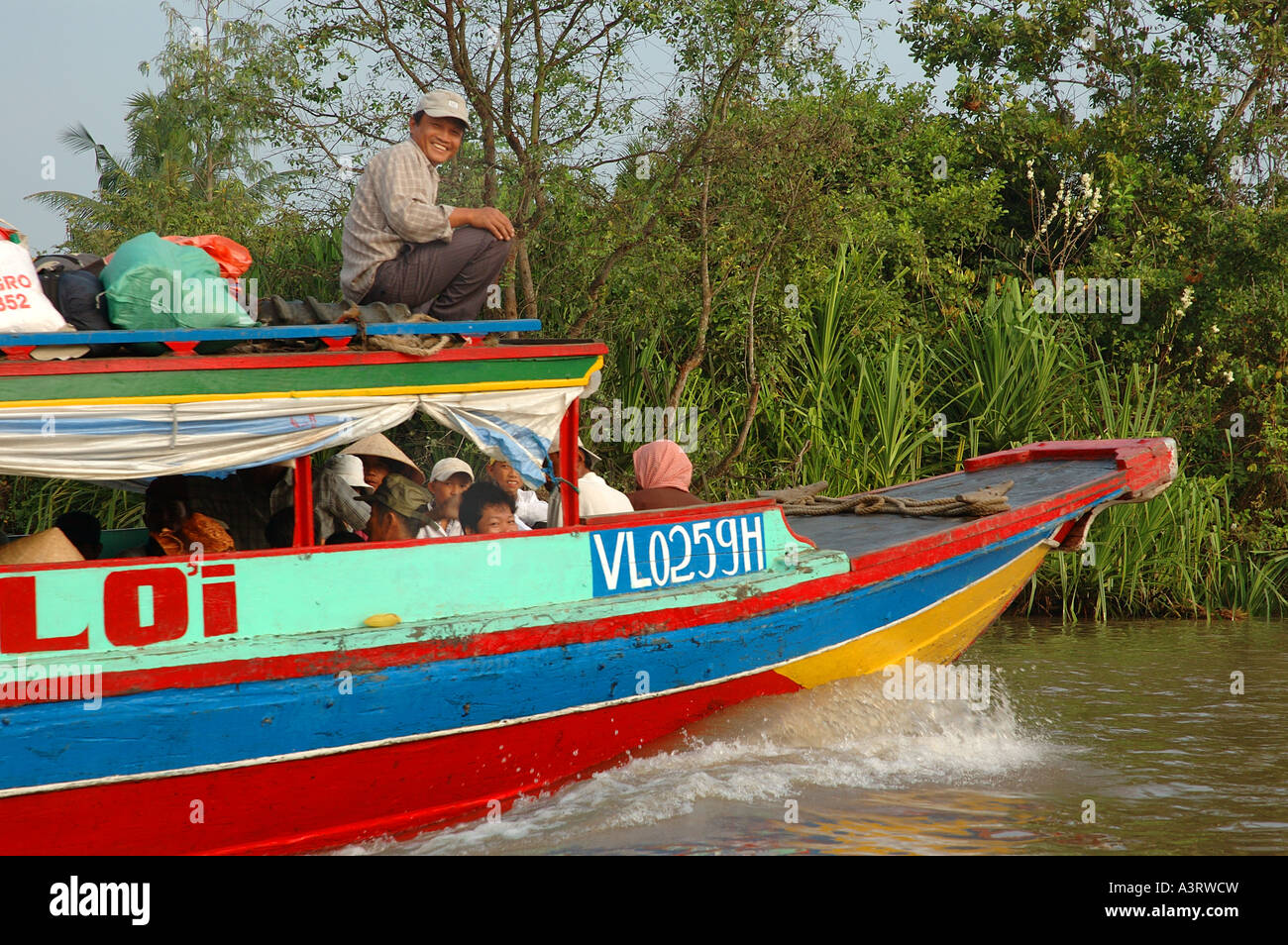 Stock photo of passengers on a ferry in the Mekong Delta in Vietnam Stock Photo
